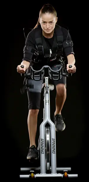 EMS Training, xBody Female riding bike dressed in EMS Suit
